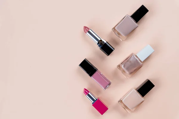 Beauty concept. Set of professional makeup cosmetic on pastel background. cosmetics set. Decorative cosmetics objects, nail bottles, lipstick.Copy space