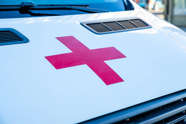 РОССИЯ, Санкт-Петербург, 21 сентября 2018.the red cross on the white hood of the ambulance.family health, charity and medicine concept.Medicine cross symbol.ambulance the car costs waiting for an
