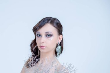 Güzel yüksek moda makyaj saç stili glitter fantezi ile kristal parlak wink, inci, boncuk, garland, jel dudaklar, kristaller, uzay kopyalayın. Kış güzellik kadın. Tatil makyaj.