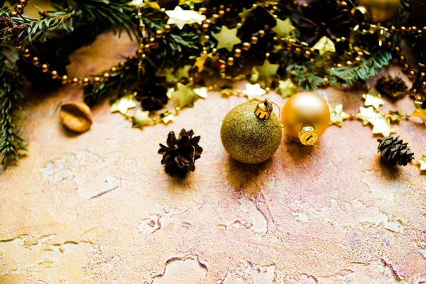 New Year or Christmas decorations isolated on a yellow background, bokeh effect.Celebration, greeting card,christmas tree concept. Selective focus,copy space. Christmas composition with gold balls — Stock Photo, Image