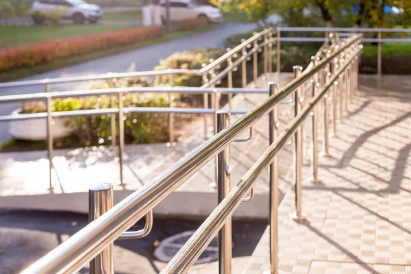 Concret ramp way with stainless steel handrail with disabled sign for support wheelchair disabled people. Health care concept.metallic stair railing outside building — Stock Photo, Image