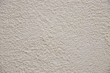 Eski sıvalı bej renk çimento duvar, yüzey dokusu keskin ve kaba beton duvar kağıdı desenli background.beige arka plan desenini kabartma. Beton duvar