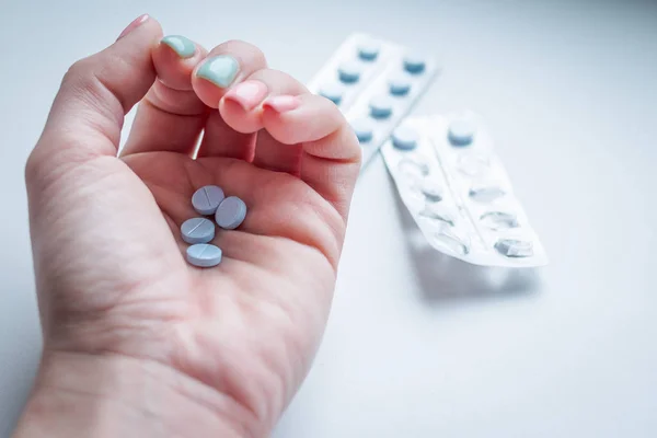 Pills, tablets and drugs heap in doctors hand. healthy lifestyle, medicine, nutritional supplements and people concept - close up of female hands holding pills.medicine, drugs, healthcare and people