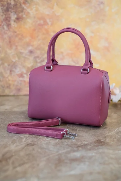 Pink clutch bag isolated on marmor background.Womens handbag, Ladies bag, Purple female clutch, pink leather clutch.Womens bag isolated