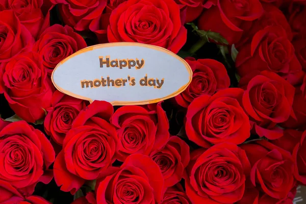 Happy Mothers Day. card concept. red heart of roses with message.Happy Mothers Day.Rose background. Mothers Day greeting card. Selective focus. flowers surprise. Greeting card.Spring holidays