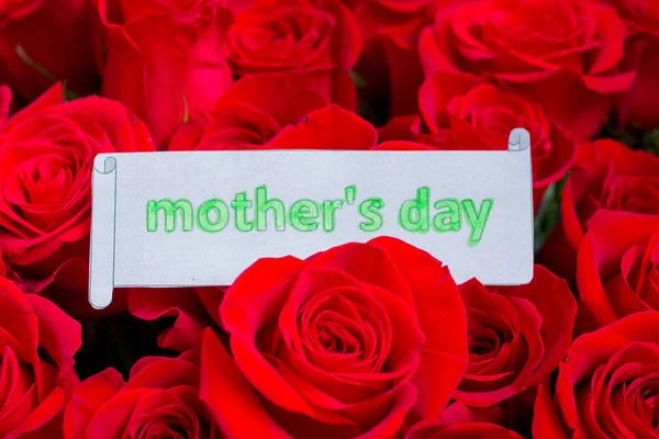 Happy Mothers Day. card concept. red heart of roses with message.Happy Mothers Day.Rose background. Mothers Day greeting card. Selective focus. flowers surprise. Greeting card.Spring holidays