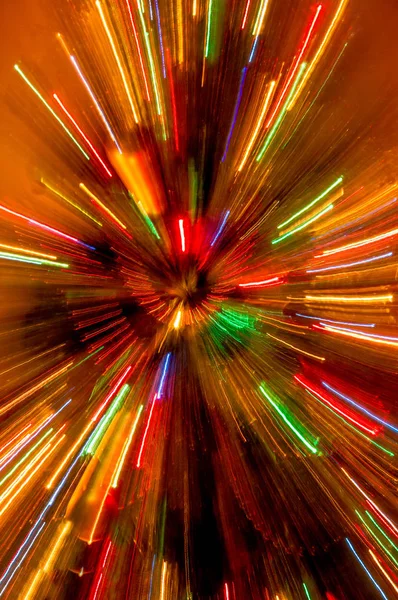 Zoomed christmas lights with streaks and light effects.festive motion colored bokeh. Golden Glitter On Shiny Red.Modern art. Long exposure neon lights texture.Long light exposure.holidays art Stock Picture