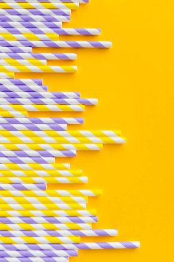 Sarı arka planda saman içen beyaz şeritli kağıt sırası. Doğum günü partisi bebek partisi davetiyesi eğlenceli çocuklar tatil konsepti. Minimalist stili. Boşluğu kopyala