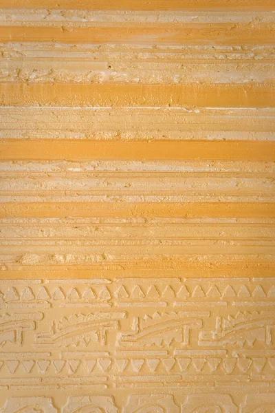 Yellow background facade plaster . Monolithic plaster decorative backdrop. cement plaster wallpaper. Gold exterior building structure backdrop. Gold paint wall concrete background , colorful yellow