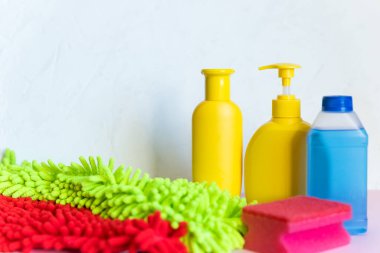 Beyaz arka planda çeşitli plastik şişeler ve kaplar ile temizlik kavramı