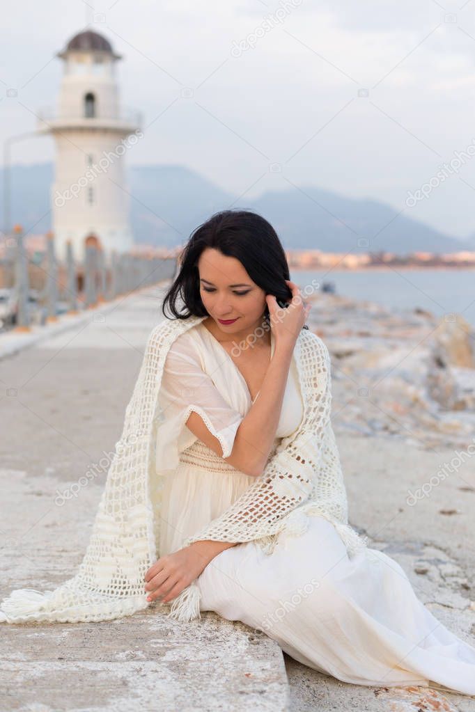 Solo female traveller sitting near the lighthouse