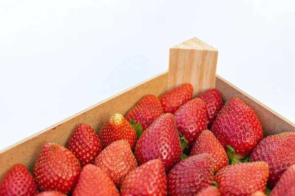 a selection of fresh strawberries on display in a box ready for sale