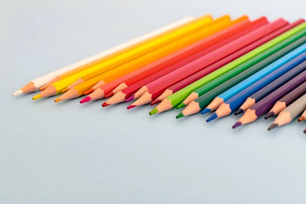 a selection of colourful sharpened pencil lined up on a table