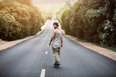 kaykaycı güneşli bir günde yolda paten sürme