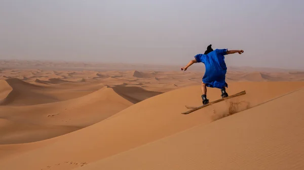 Back View Sandboarder Dressed Touareg Gandoura Performing Jump Trick While — Stock Photo, Image