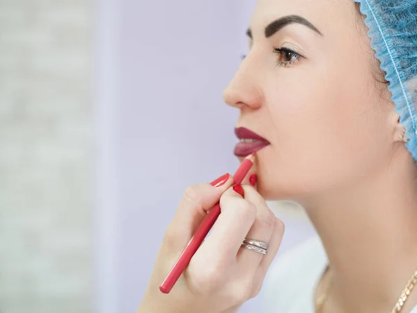 Maquillaje permanente borgoña lápiz contorno labios — Foto de Stock