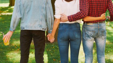 polyamorous relationship woman standing two guys clipart