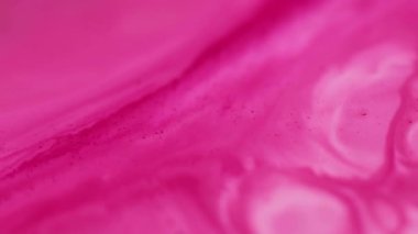 Mürekkep lekeleri. Karışım akışı. Soyut sanat arka planında yüzen odaksız pembe renkli su mermeri parçacıkları kimyasal sel dokusu.