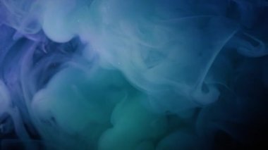 Sis sıvısı. Boya buharı. Mavi yeşil buhar pigmenti siyah menekşe üzerine dökülüyor. Soyut sanat sıvısı. Odaklanmış su sıçraması..