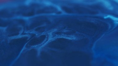Akrilik pigment. Mermer dokusu. Odaklanmamış mavi renk boya sıvısı parçacıkları sıvı emülsiyon soyut sanat koyu arkaplan üzerine yayılıyor.
