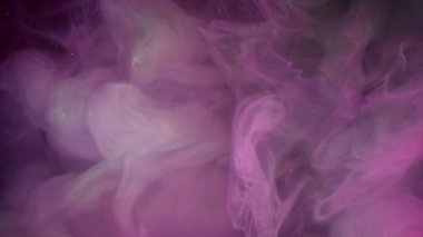 Sis sıçraması. Dumanı karıştır. Pembe yeşil boya sıvısı siyah bulanık dokuya dökülüyor. Sanat karışımı renk soyut akış odaklı olmayan arkaplan.