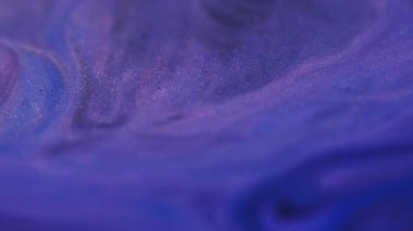 Dalgalı boya. Parlak sıvı. Bulanık mavi mor toz rengi kimyasal akış soyut akrilik sanat arka planına yayılan koyu siyah lekeler.