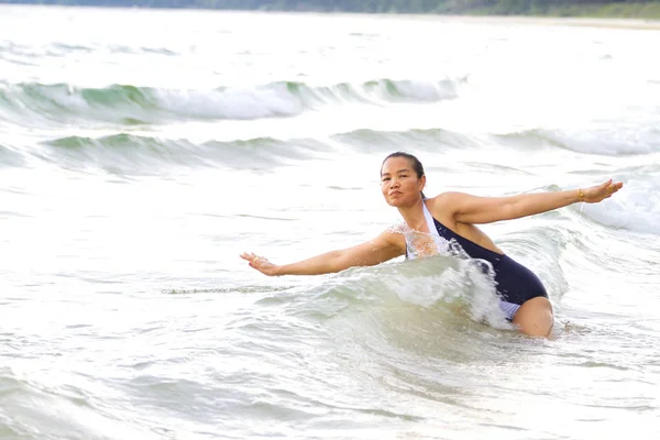 Woman shape large and bikini enjoy on wave at beach 