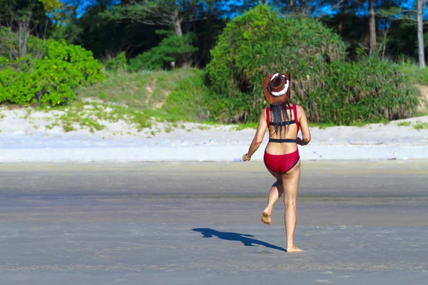 Woman with bikini crimson enjoy and exercise on beach — Stockfoto