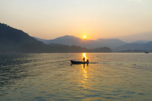 Sunrise in the morning and silhouette fisherman at Koh Chang Thailand