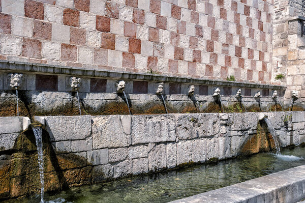 Fountain of the 99 Spouts (Fontana delle 99 cannelle), Historic fountain with 99 jets distribuited along three walls, L Aquila, Italy