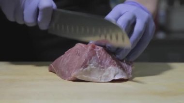 Şef tahtadan et kesiyor.