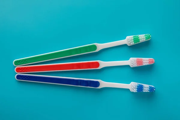 Toothbrushes in the form on a blue background — Stock Photo, Image