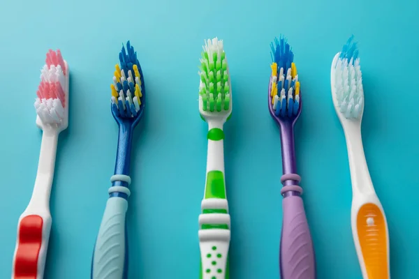 Toothbrushes in the form on a blue background — Stock Photo, Image