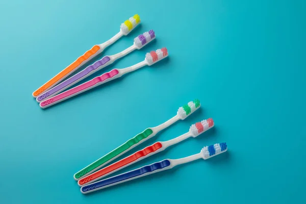 Toothbrushes in the form on a blue background — Stock Photo, Image