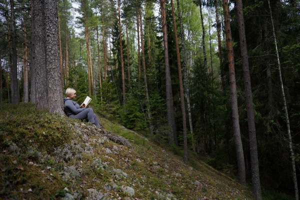 Dívka čte knihu v lese — Stock fotografie