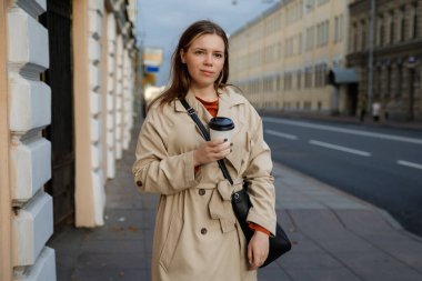 Sokakta tek kullanımlık bardaklı bir kadın.