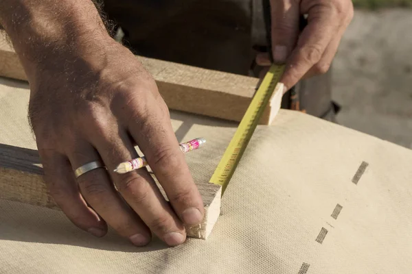 Roof construction building. Man measuring elements with tape measure or scoop.