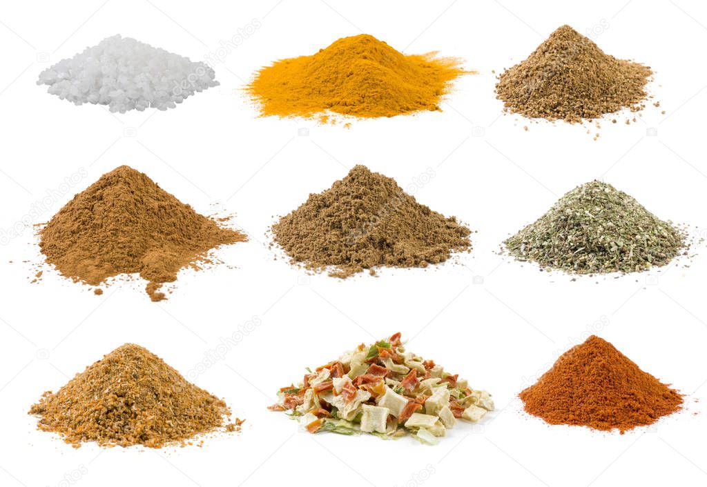 Set of spices and food ingredients in heaps isolated on white background