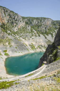 Mavi göl Imotski Hırvatistan, güzel doğa ve manzara fotoğrafı çok büyük ve derin Düden Dalmaçya dağlarda. Güzel güneşli yaz günü. Su, kayalar ve taşlar. Tatile ziyaret etmek için harika yer.