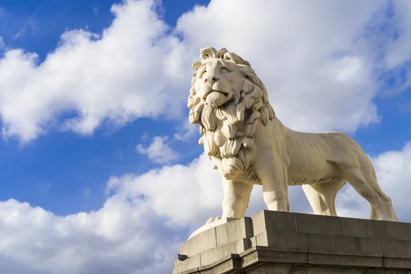 close up of white lion statue on blue sky background