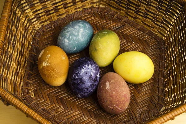 Beautiful natural colored Easter eggs in basket. Raw organic food with color from only natural ingredients.