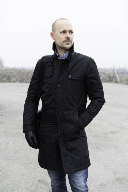 Adam açık havada duran siyah giysili 