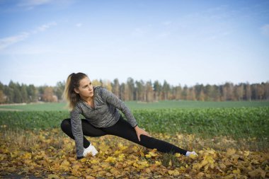 Genç kadın açık havada egzersiz yaparak spor giyim 