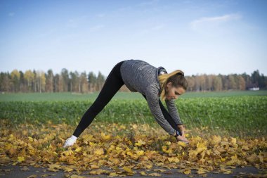 Genç kadın açık havada egzersiz yaparak spor giyim 