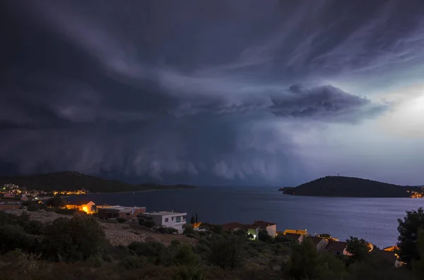 view of thunderstorm starting over town on seashore