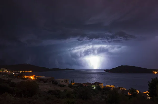 view of thunderstorm starting over town on seashore