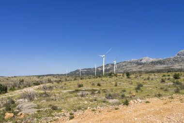 View of the mountains with wind power plant