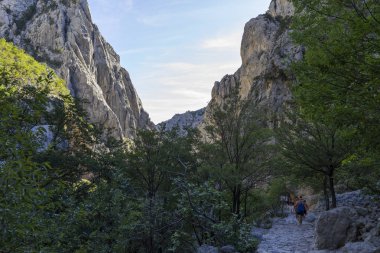 view of the people trekking in the rocky mountains