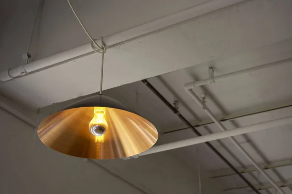 Copper lamp on the ceiling and water hose
