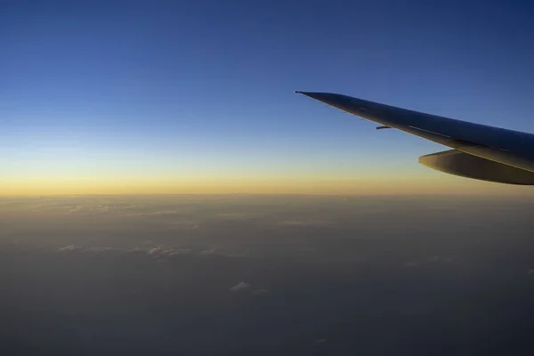 Plane wings with the sky in evening